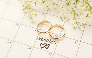 Two wedding rings placed on calendar with wedding date highlighted