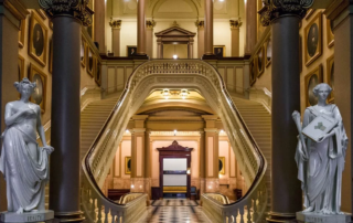 Hallway with statues and staircases on either side