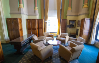 Room with chairs surrounding a table