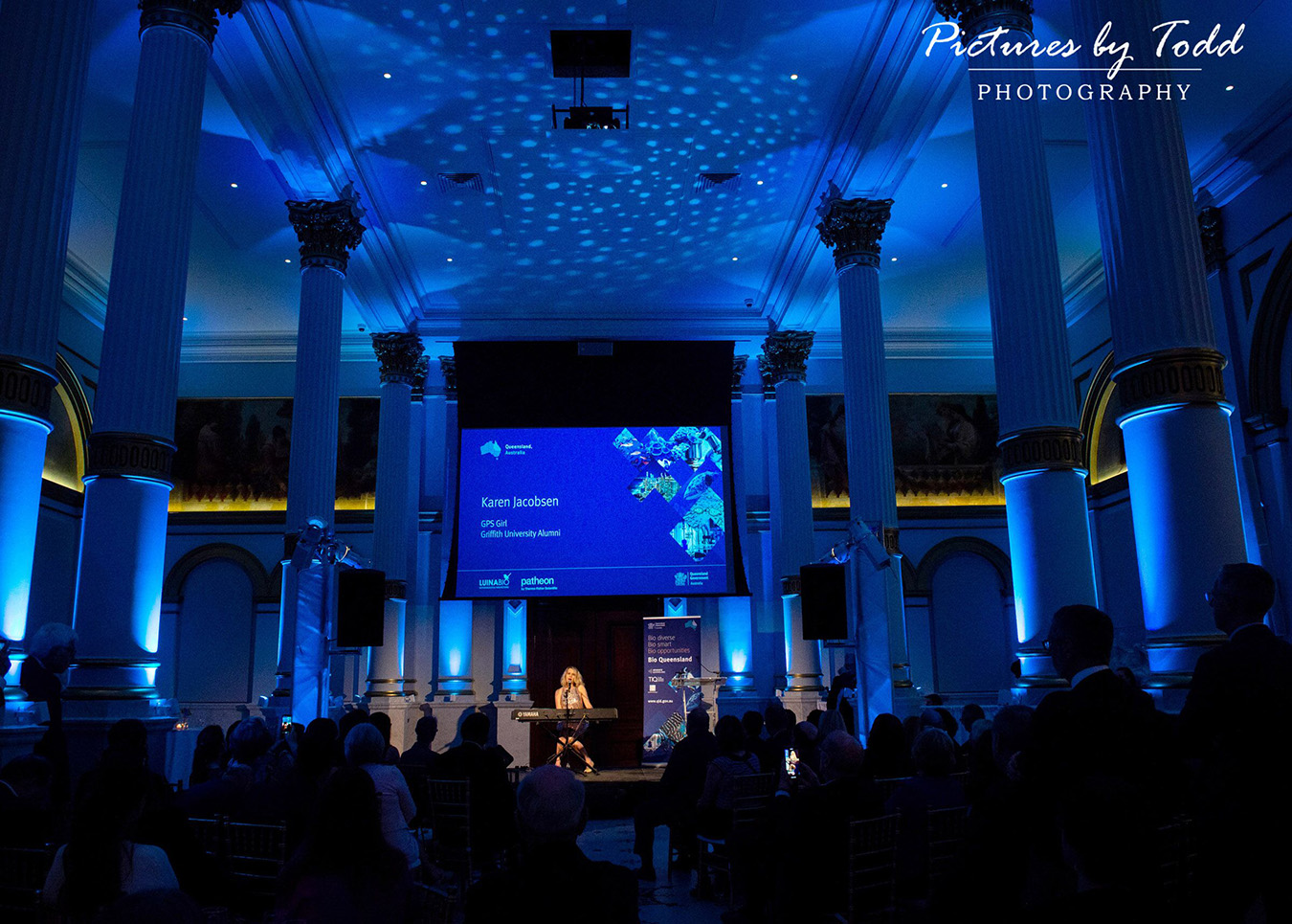 Corporate ballroom with stage and blue lighting