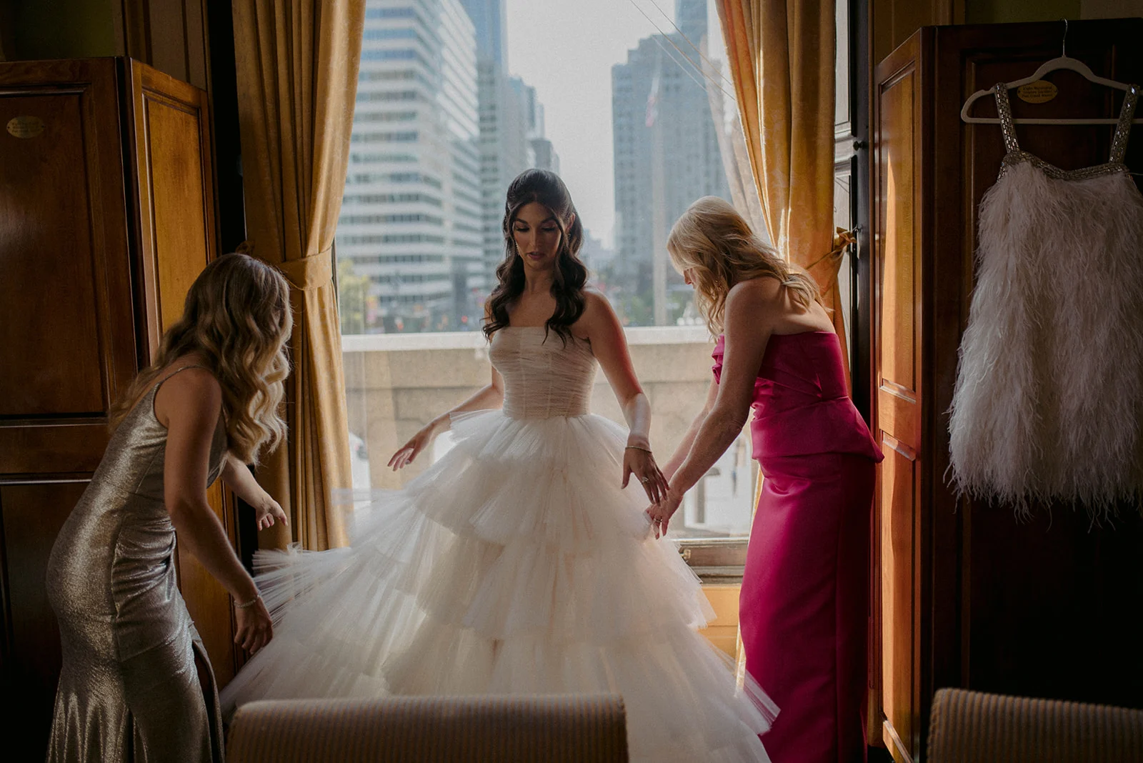 CASEY & TREVOR woman getting dressed in wedding gown
