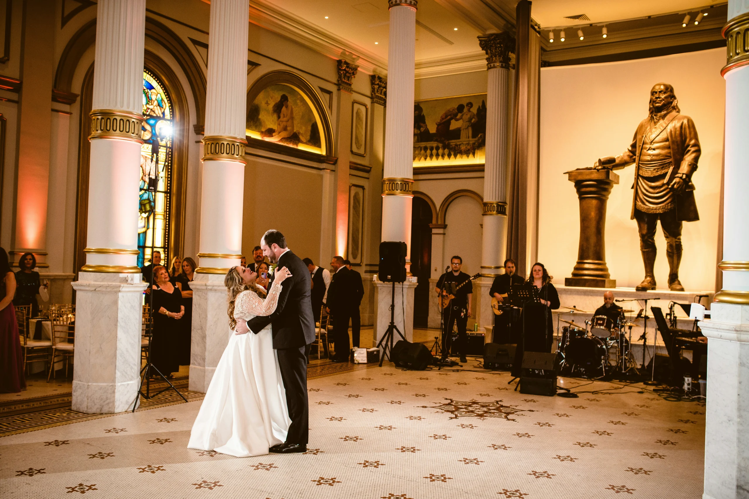 Bride and groom dancing in ballroom