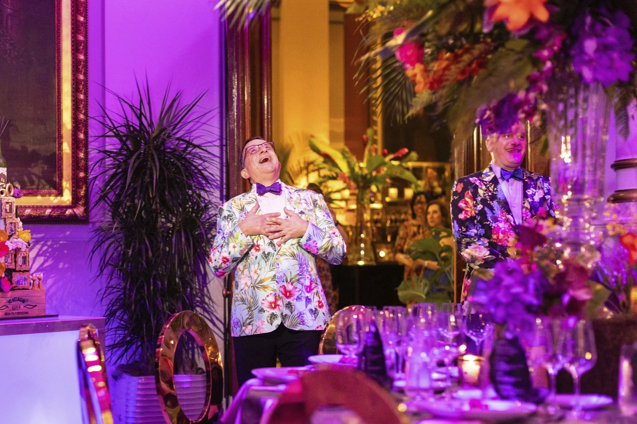 Men laughing in tropically decorated room