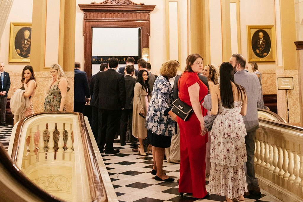 Hallway filled with guests talking