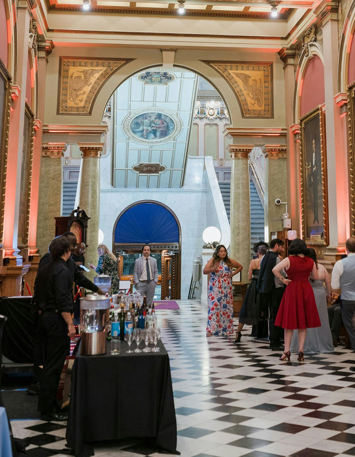 Hallway filled with guests and drink serving station
