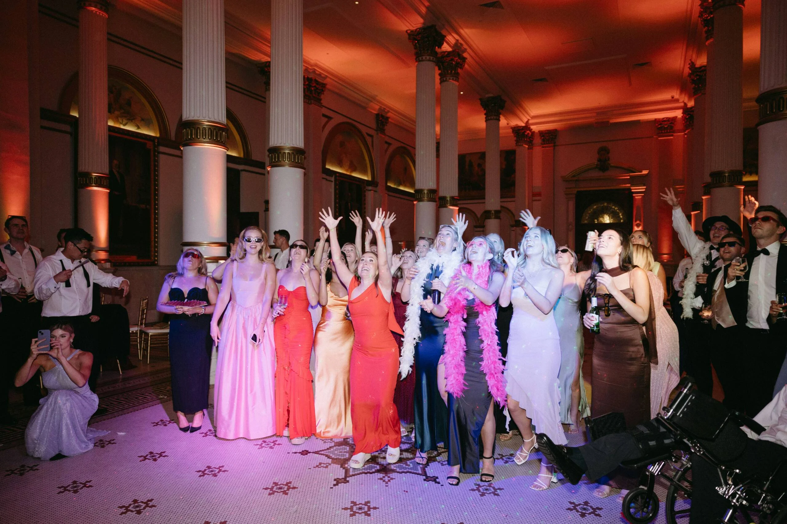 next-level-photo1-scaled Group dressed in reds catching bouquet