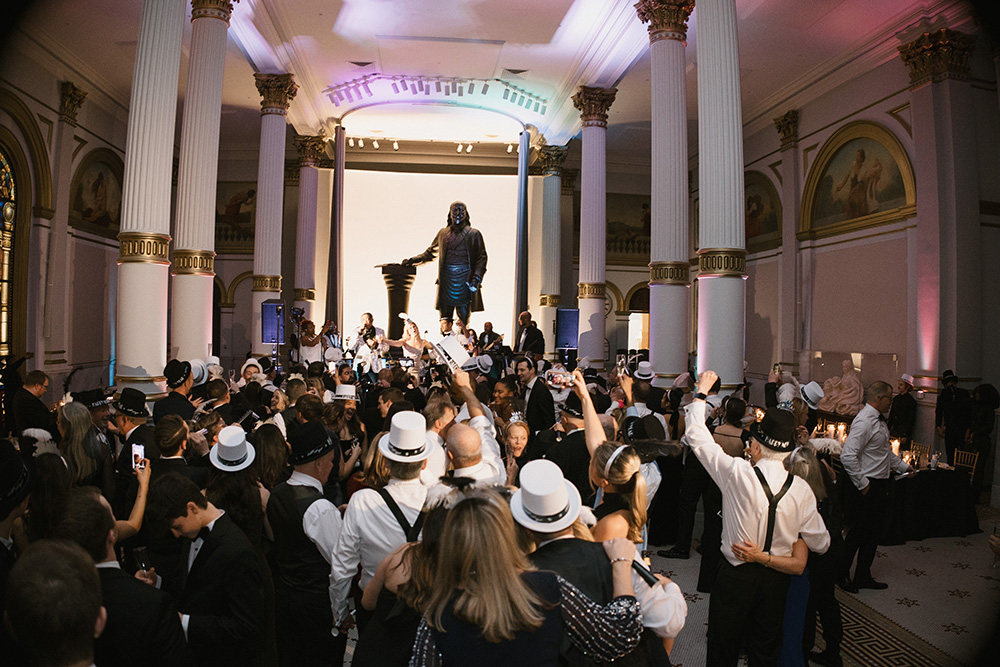 12_31_24_J_M_Wedding_-1996sm Group of people dancing on ballroom floor.