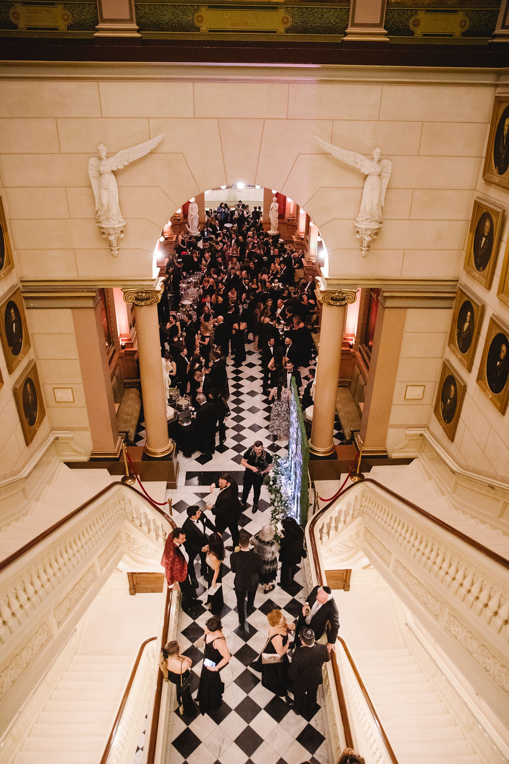 Asya Photography (2) Large foyer with formally-dressed crowd framed by an archway and staircases.