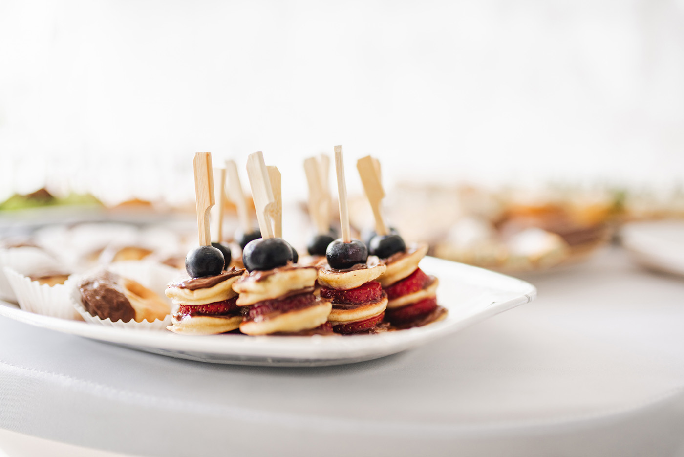 Bite-sized pancake stacks set on a plate.