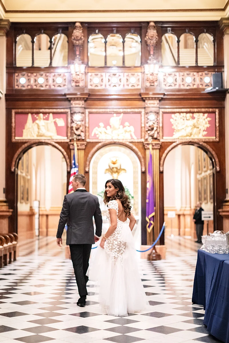 Joshua Michael Johnson (4) Bride and groom walking together in foyer.