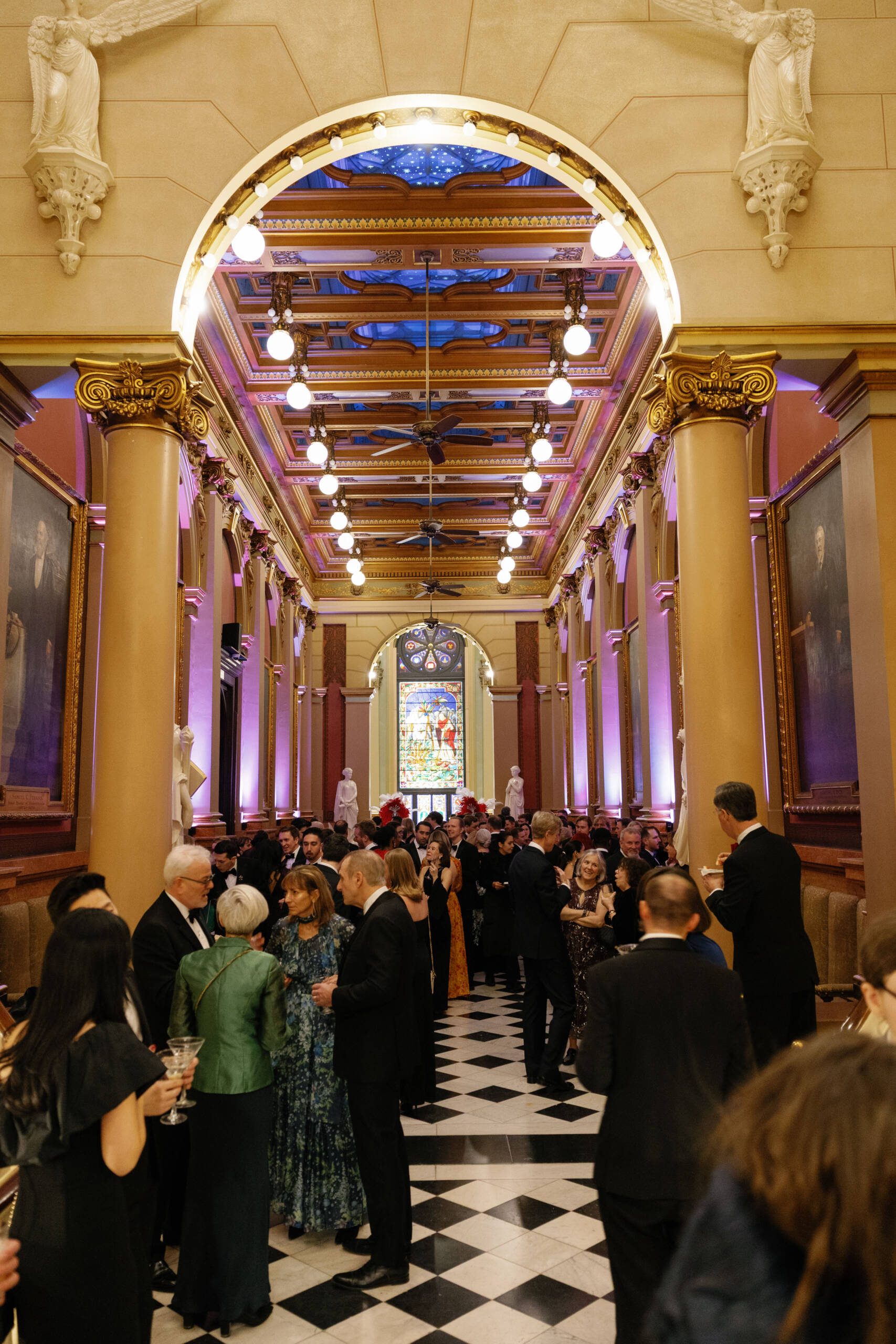 Daria M. Photography 3 Group dressed in formal attire gathered in ornate foyer.