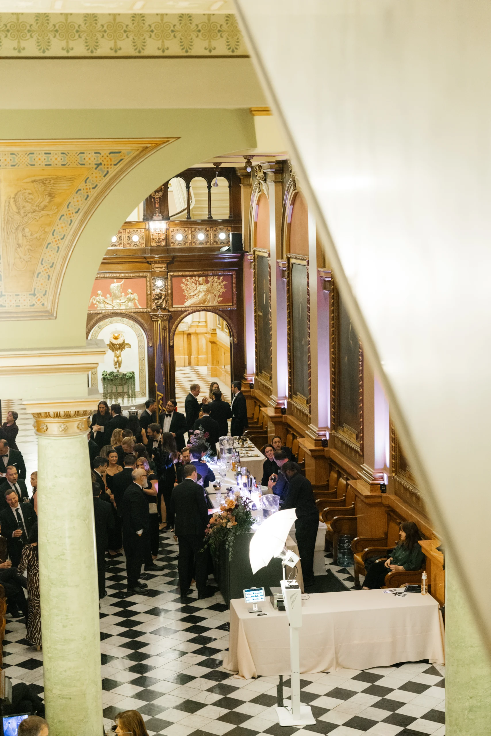 Daria M. Photography 4 Large, formally dressed group gathered in long foyer with arch overhead.